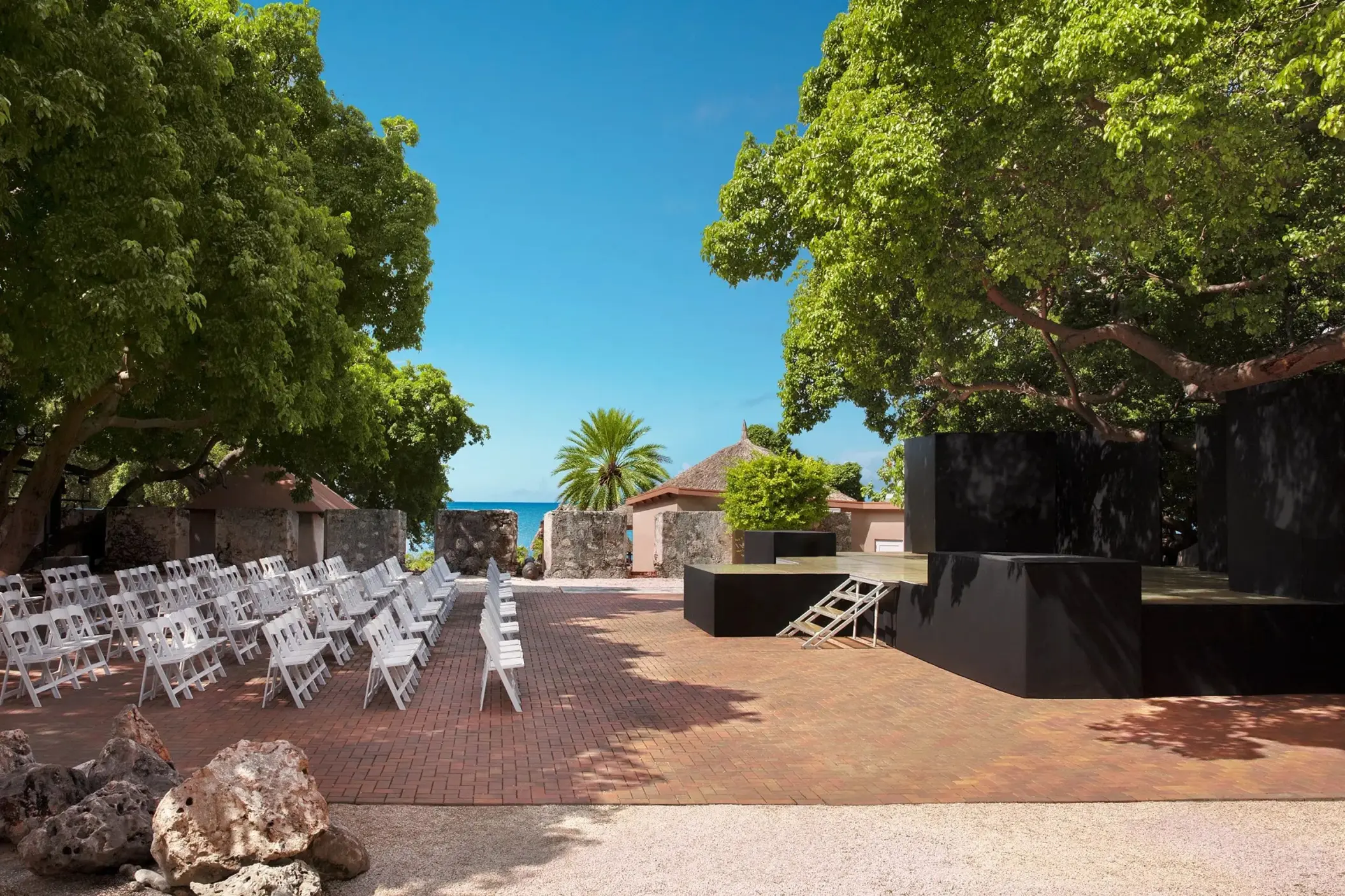 18th-century fort wedding ceremony with white chairs at Dreams Curacao, Willemstad