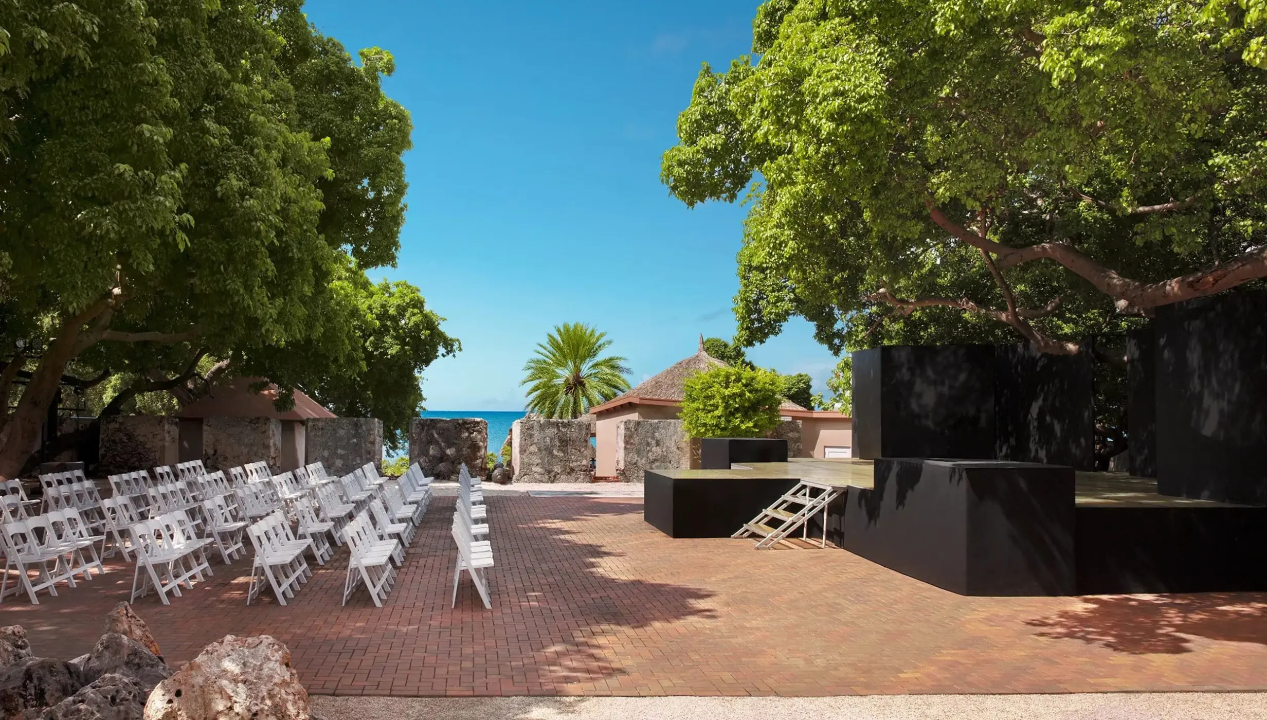 18th-century fort wedding ceremony with white chairs at Dreams Curacao, Willemstad