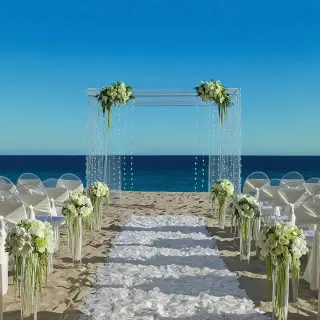 Beachfront wedding ceremony with white floral arch and ghost chairs at Dreams Curacao, Willemstad