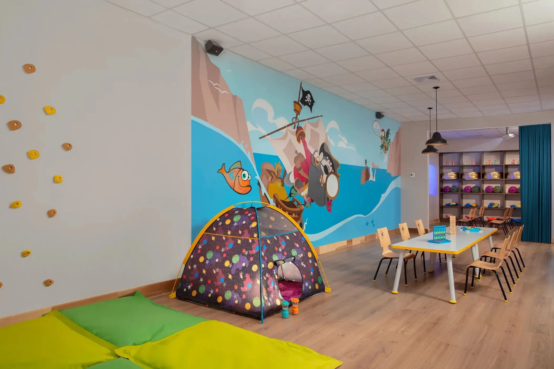 Explorer's Club kids playroom with pirate mural and climbing wall at Dreams Curacao, Willemstad