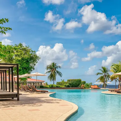 Infinity pool with cabanas and lounge chairs at Dreams Curacao, Willemstad