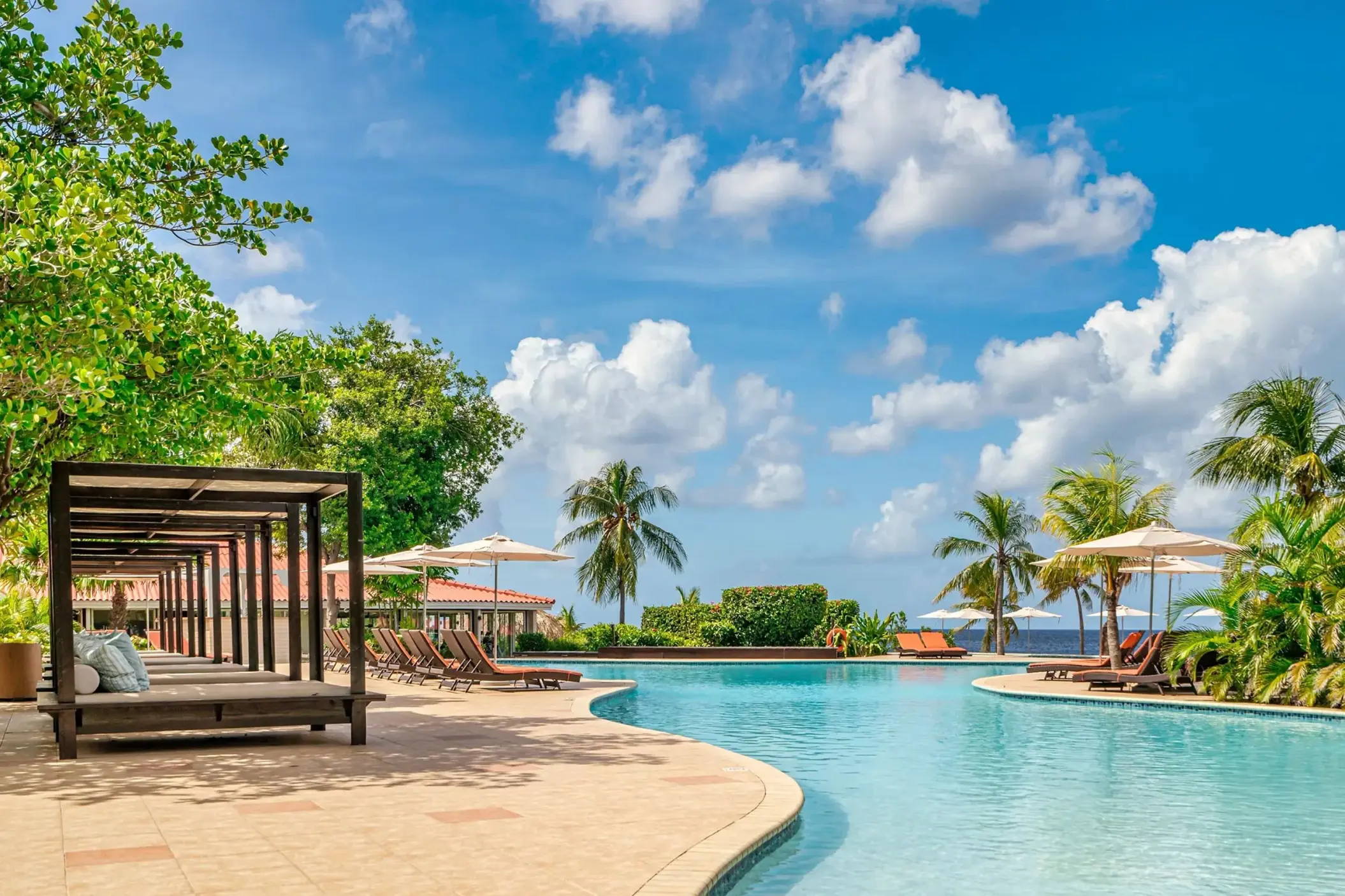 Infinity pool with cabanas and lounge chairs at Dreams Curacao, Willemstad