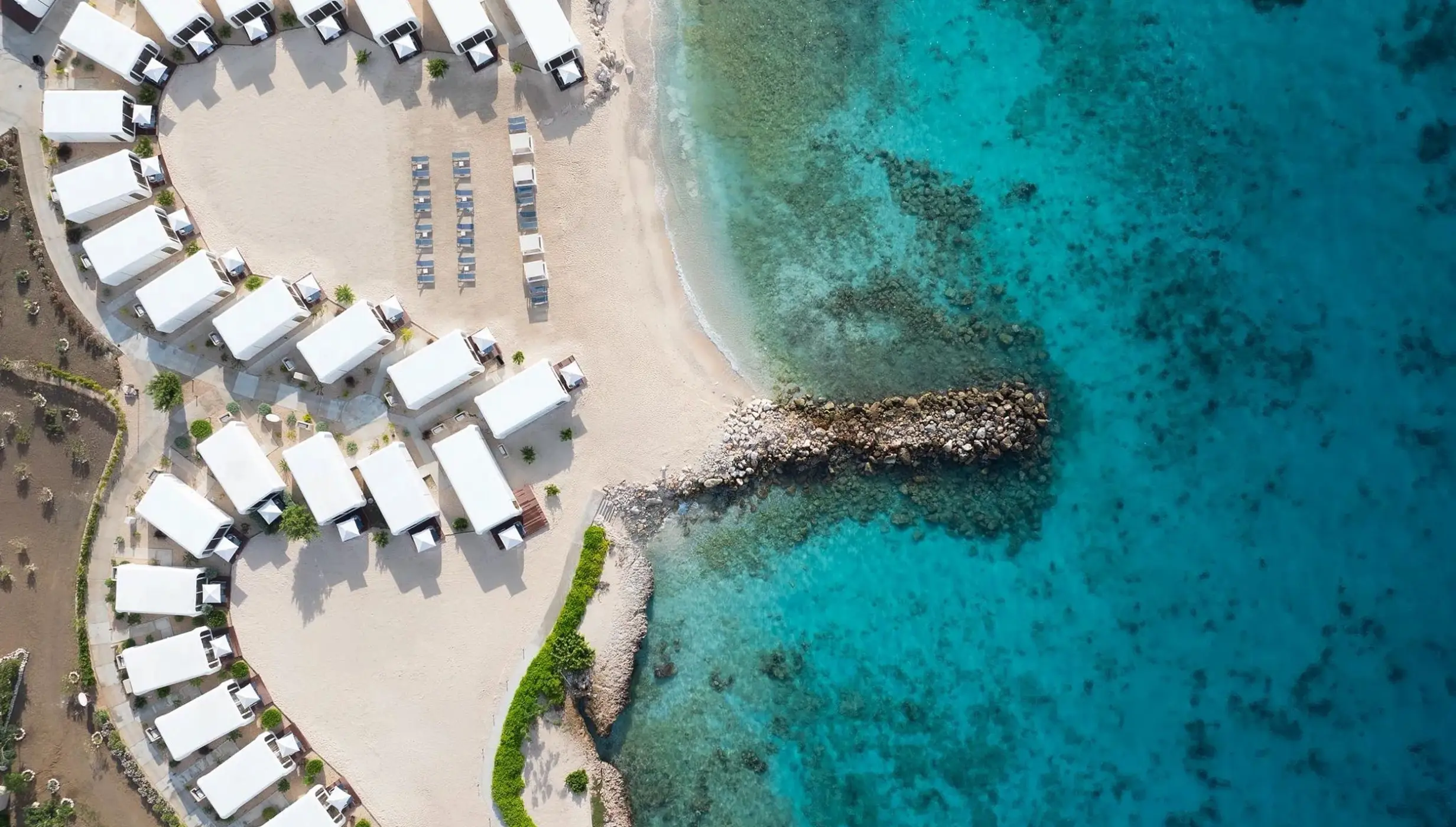 Aerial view of beach wedding venue with white tents at Dreams Curacao, Willemstad