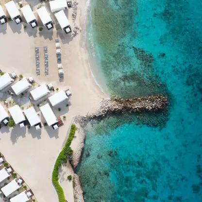 Aerial view of beach wedding venue with white tents at Dreams Curacao, Willemstad