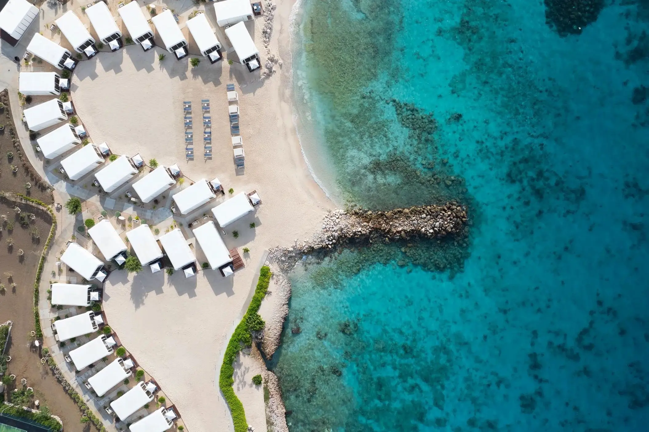 Aerial view of beach wedding venue with white tents at Dreams Curacao, Willemstad