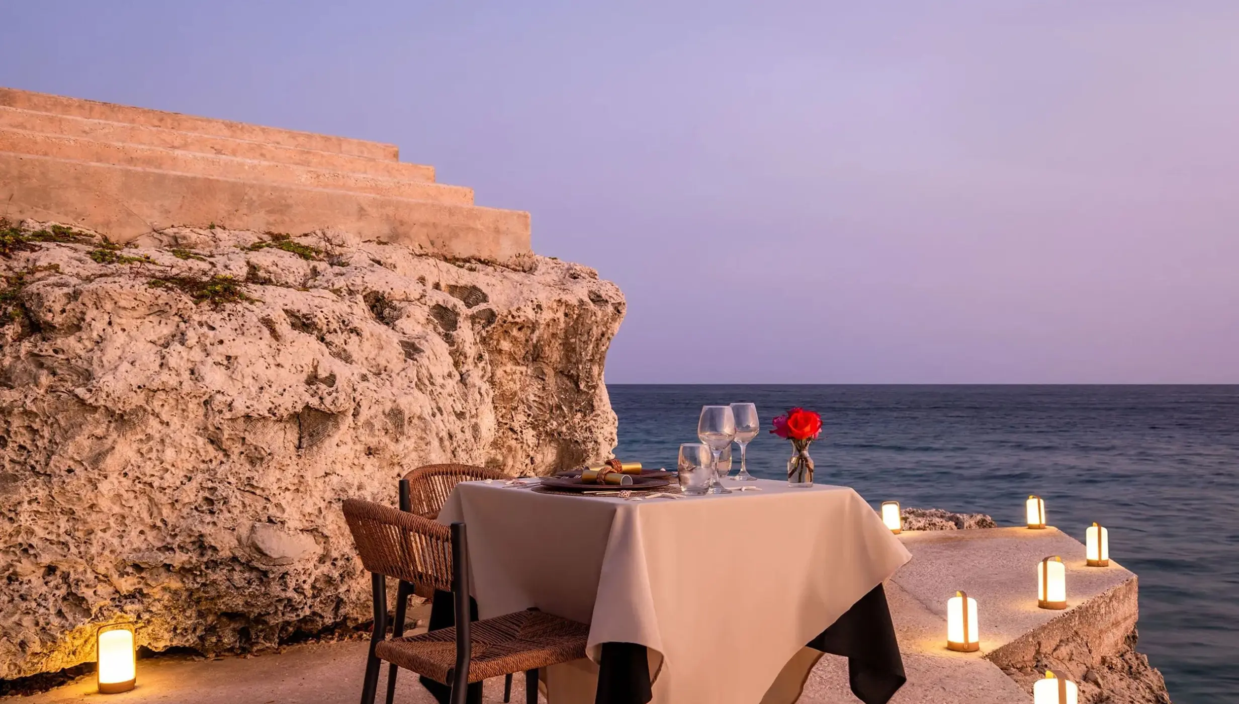 Private wedding dinner on the rocks with lanterns at Dreams Curacao, Willemstad