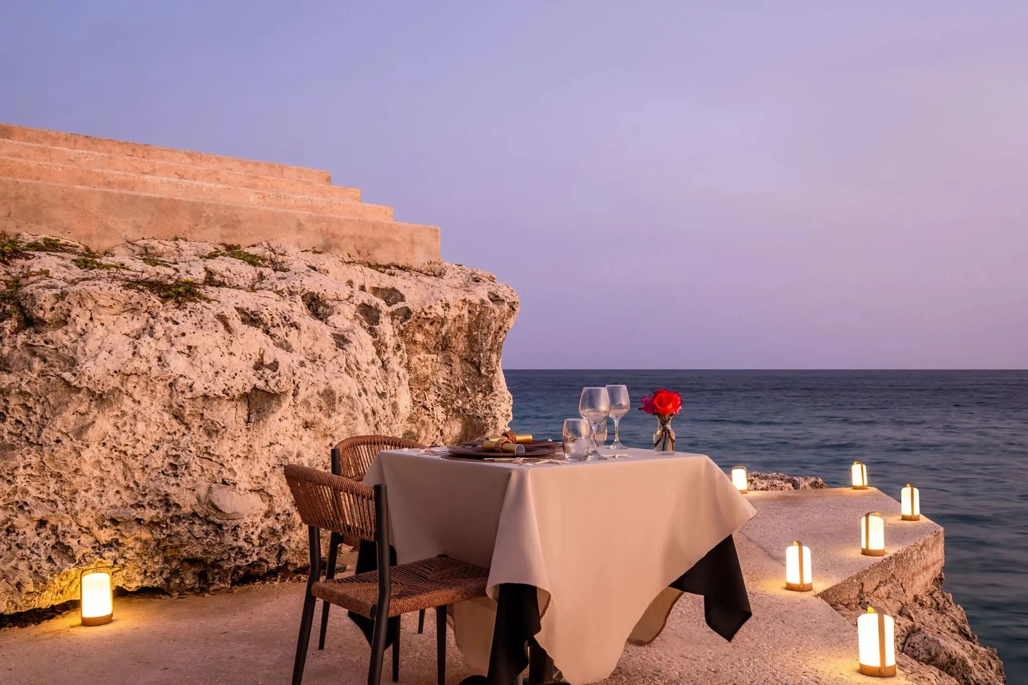 Private wedding dinner on the rocks with lanterns at Dreams Curacao, Willemstad