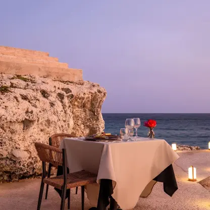 Private wedding dinner on the rocks with lanterns at Dreams Curacao, Willemstad