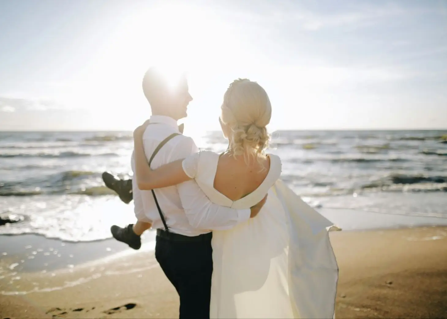 Groom carrying the bride on the beach at Dreams Dominicus