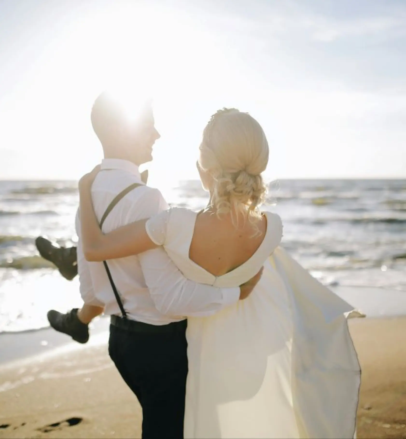 Groom carrying the bride on the beach at Dreams Dominicus