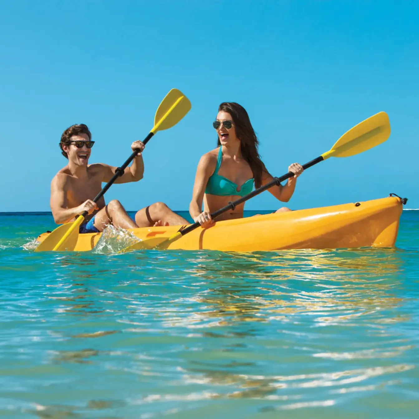 Couple kayaking in turquoise water at Dreams Dominicus, La Romana