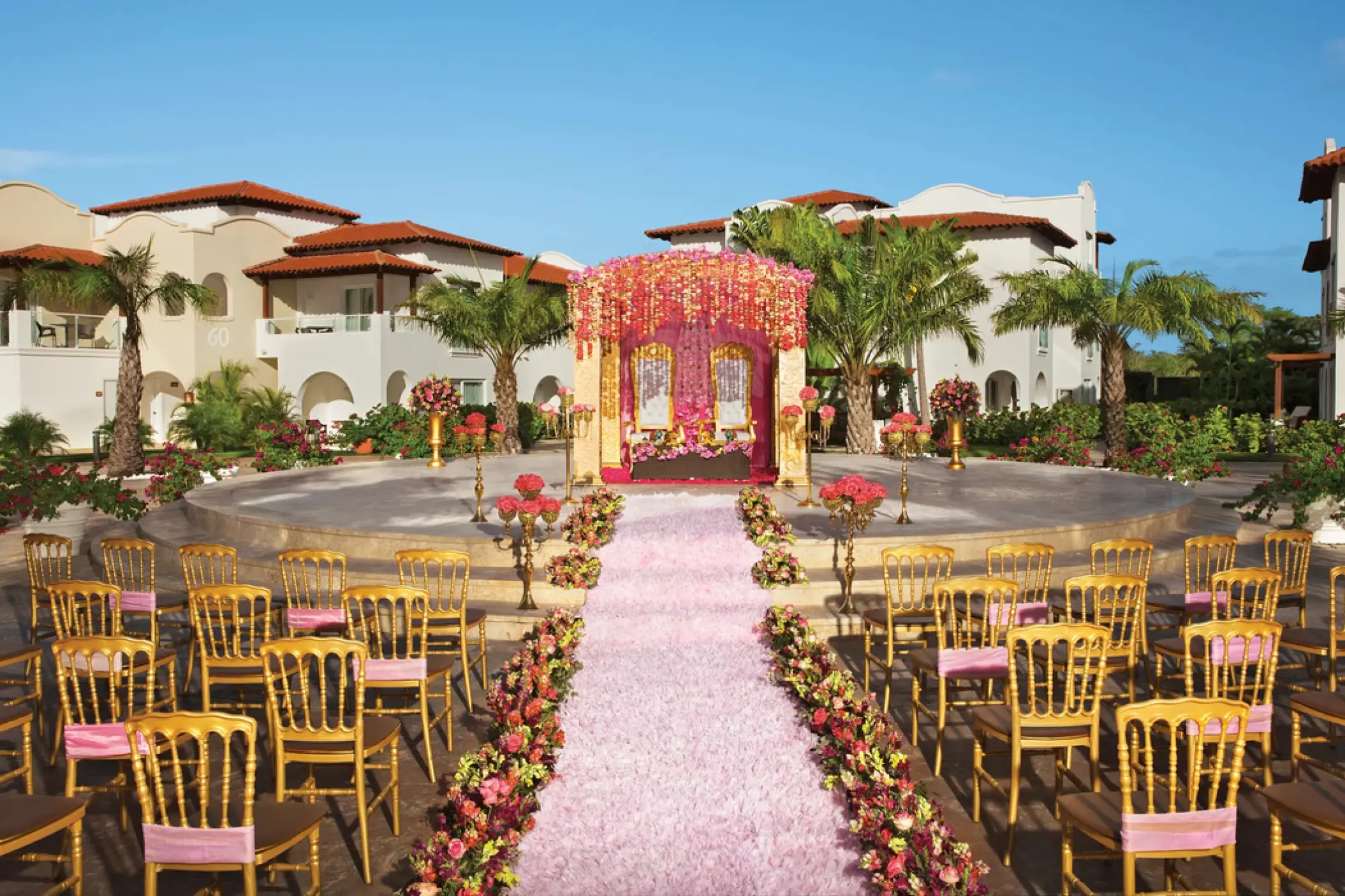 Mandap and pink floral aisle for a wedding ceremony at Dreams Dominicus, La Romana