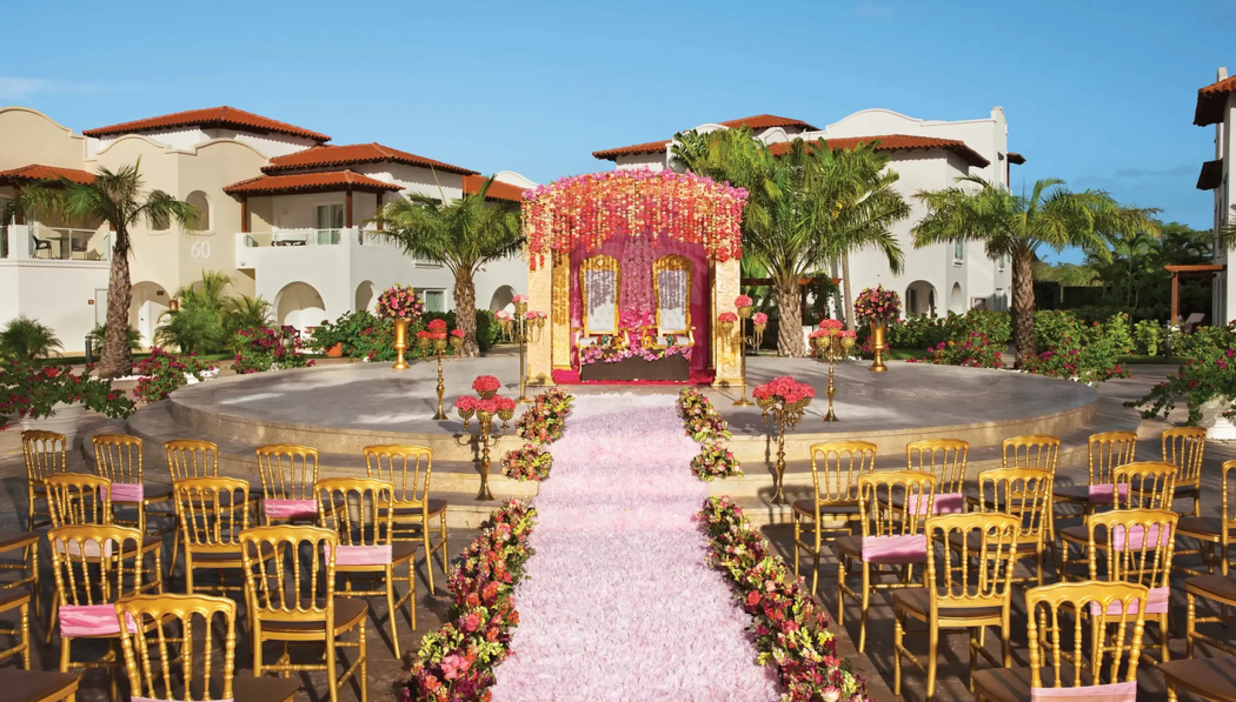 Mandap and pink floral aisle for a wedding ceremony at Dreams Dominicus, La Romana