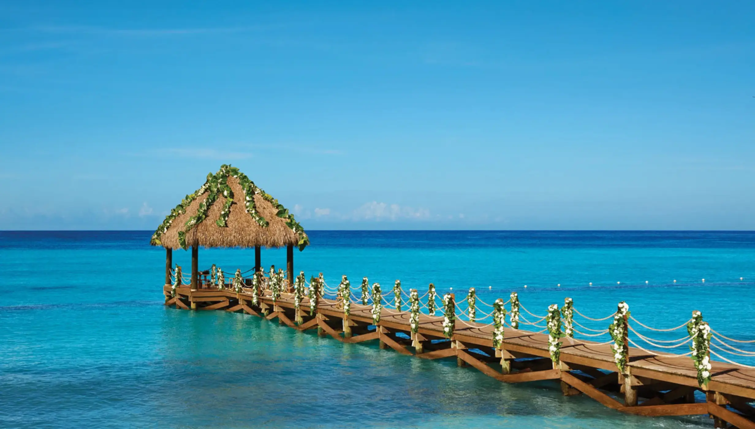 Pier wedding ceremony venue over turquoise water at Dreams Dominicus, La Romana