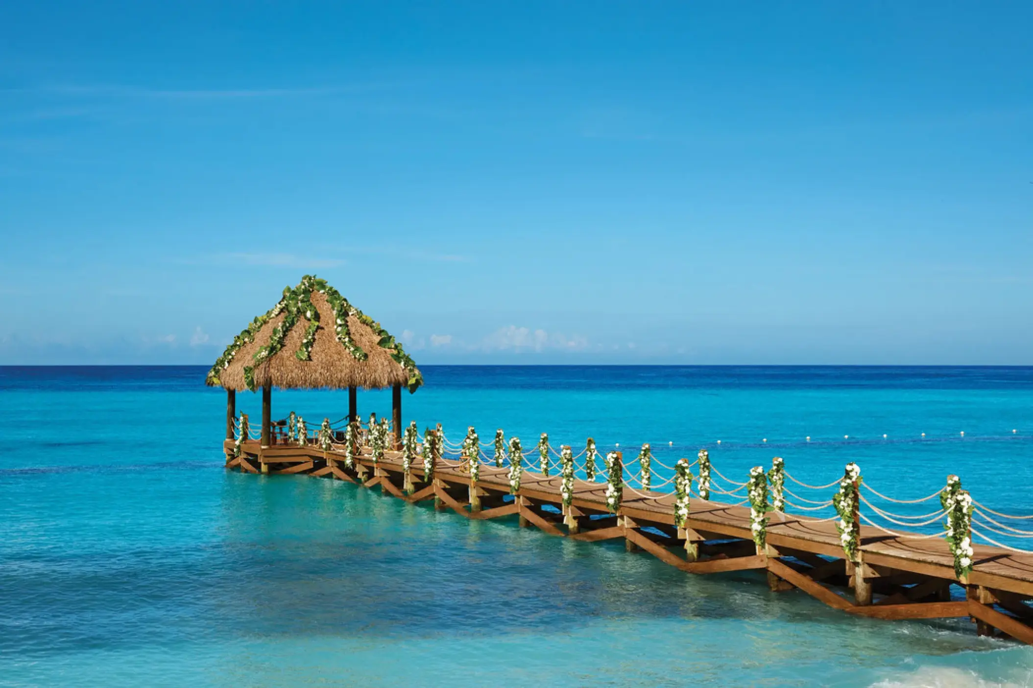 Pier wedding ceremony venue over turquoise water at Dreams Dominicus, La Romana