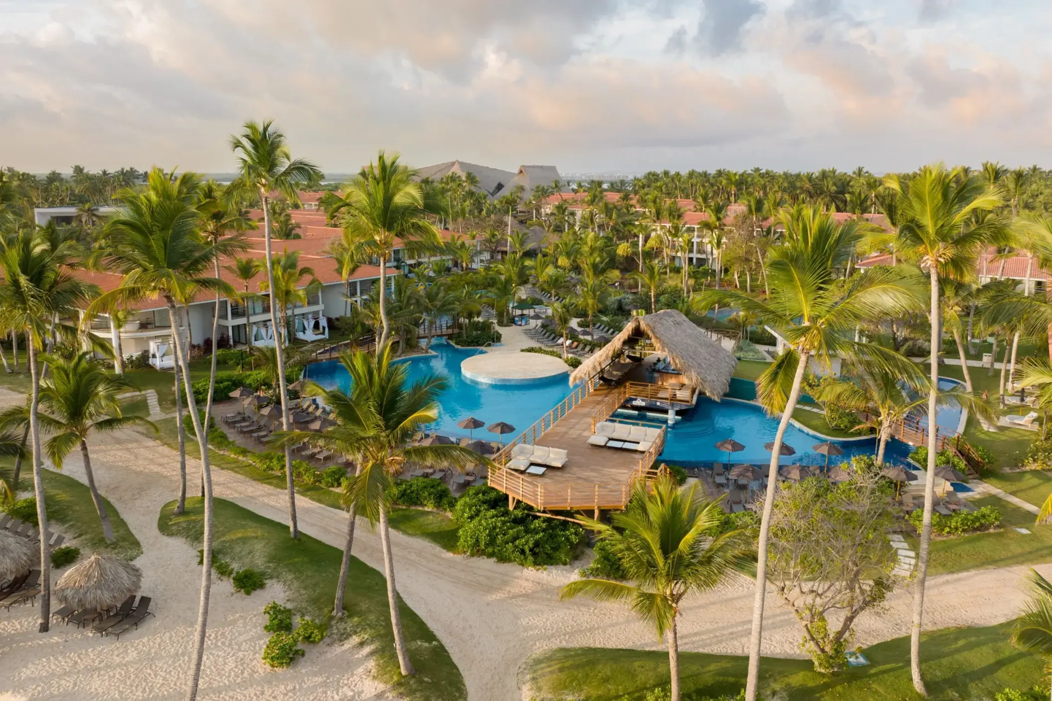 Aerial view of swimming pools and palm-lined grounds at Dreams Flora, Punta Cana