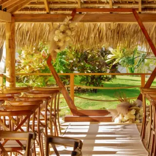 Palapa wedding ceremony with a wooden hexagonal arch at Dreams Flora, Punta Cana