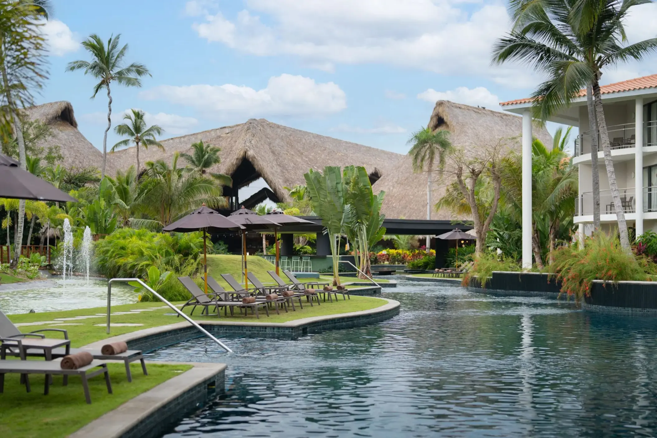 Dreams Flora pool and sun loungers surrounded by tropical greenery, Punta Cana