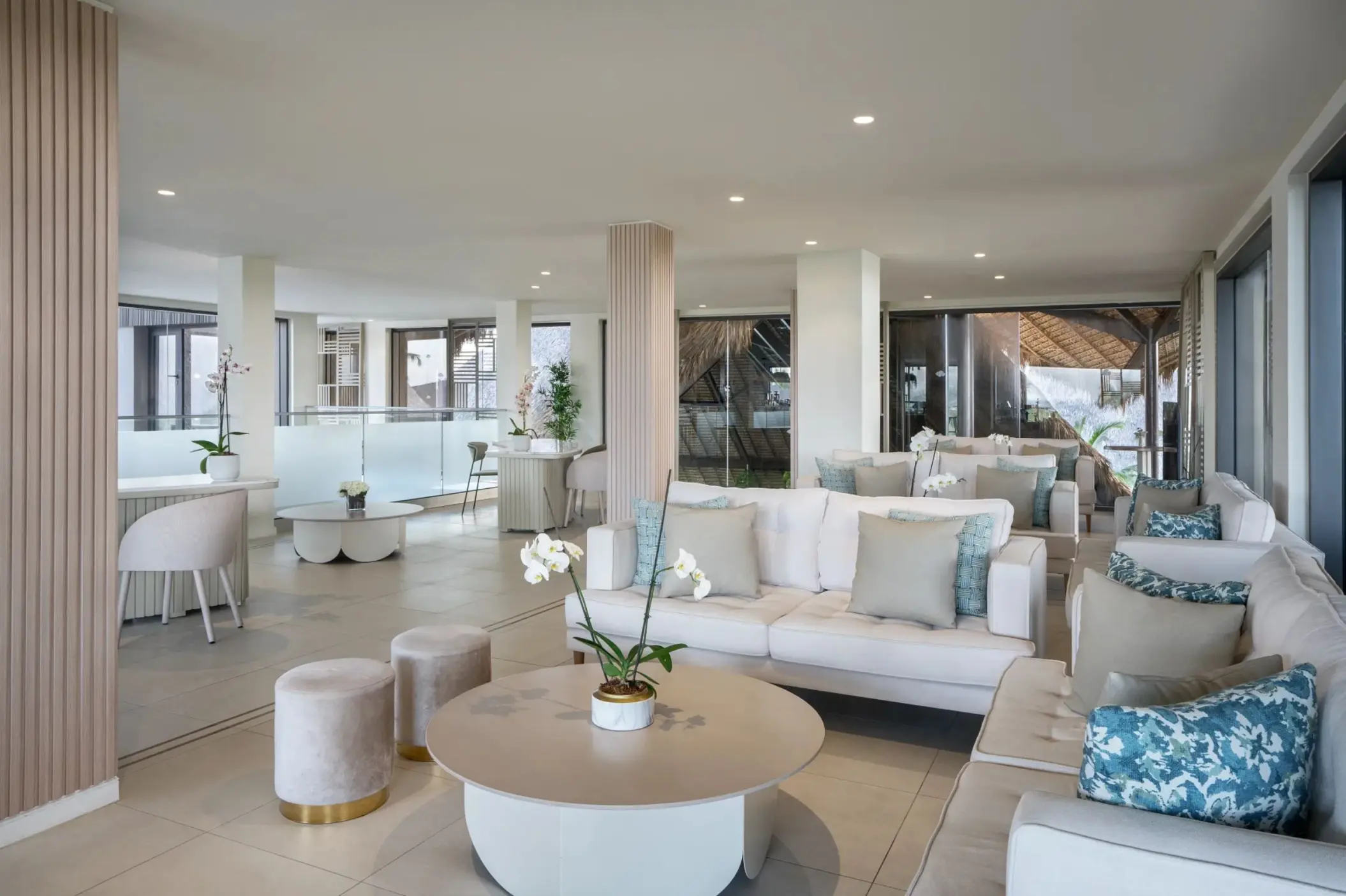 Preferred Club lobby lounge area with white sofas and blue accents at Dreams Flora, Punta Cana