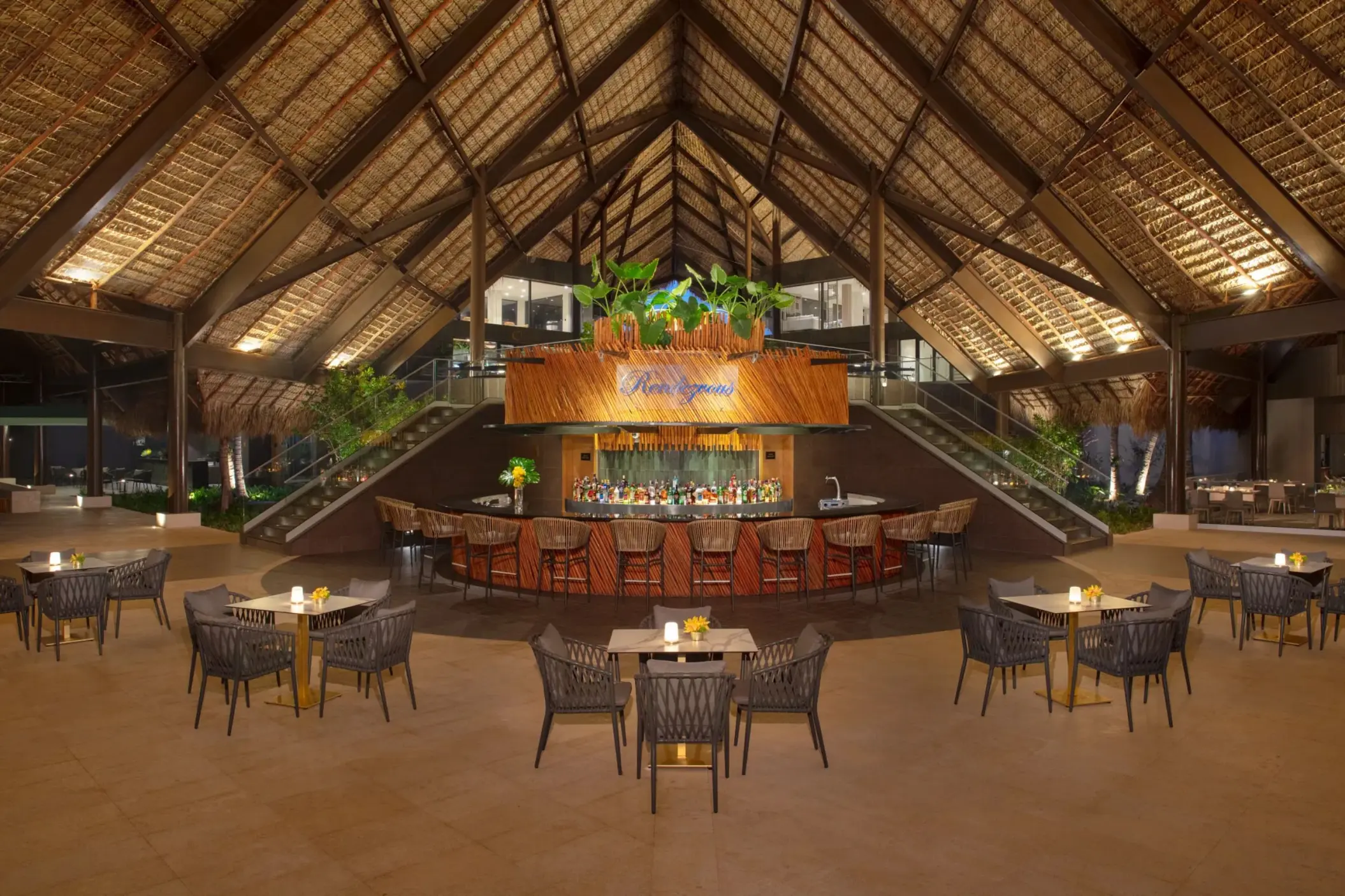 Rendezvous lobby bar with a high thatched ceiling at Dreams Flora, Punta Cana