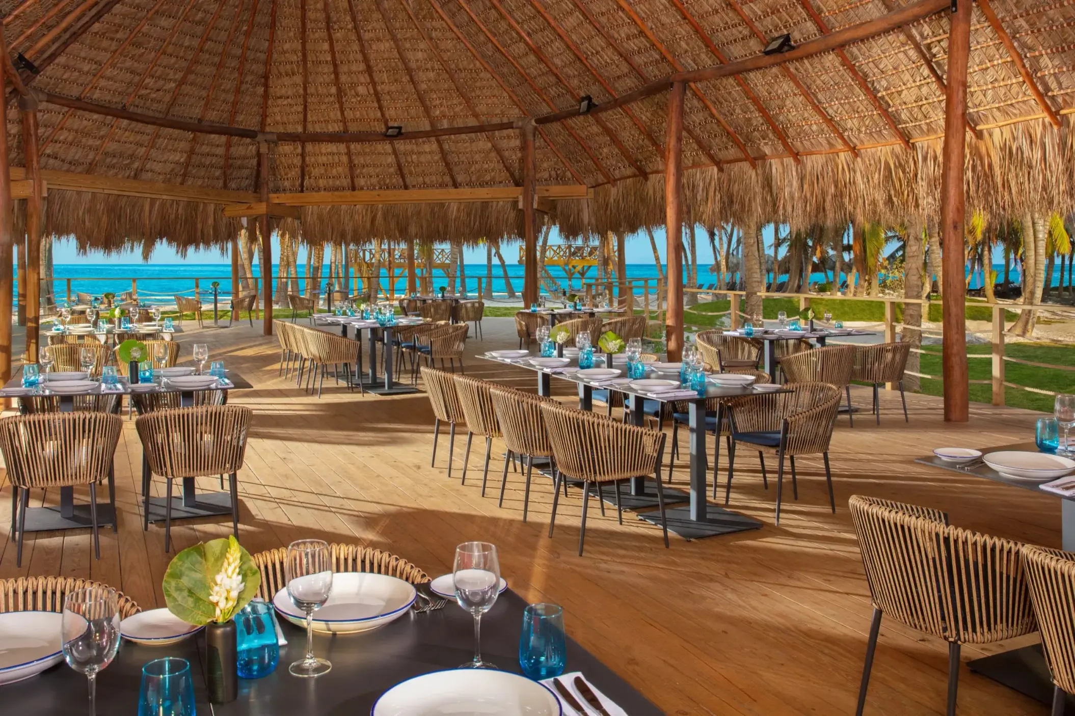 Seaside Grill open-air restaurant with thatched roof at Dreams Flora, Punta Cana