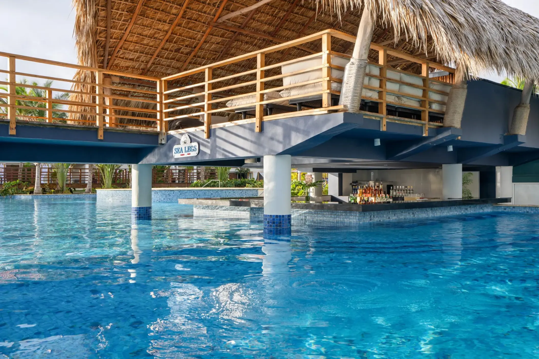 Swim-up bar with thatched roof at Dreams Flora, Punta Cana