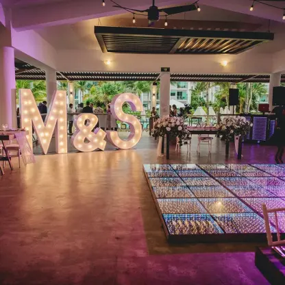 Castaways restaurant wedding reception with light-up letters and dance floor at Dreams Jade, Riviera Maya