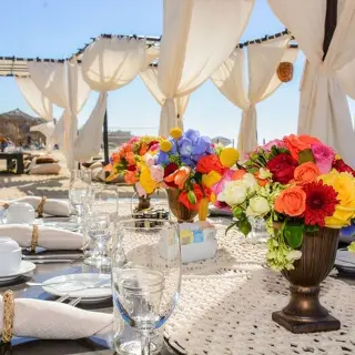 Colorful floral centerpieces on a reception table at Dreams Los Cabos, Cabo San Lucas