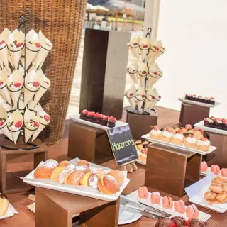 Wedding dessert table with pastries and macarons at Dreams Los Cabos, Cabo San Lucas