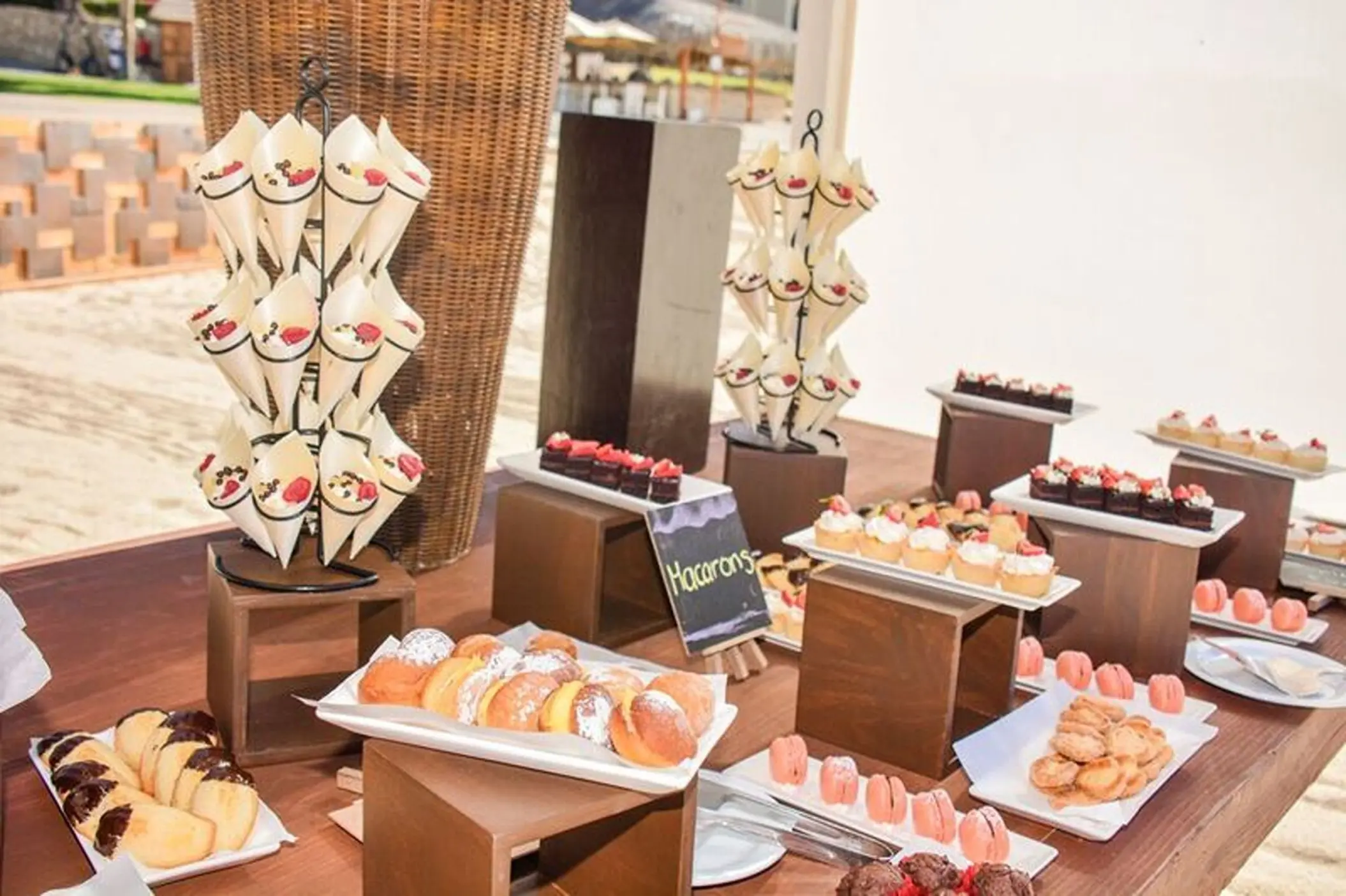 Wedding dessert table with pastries and macarons at Dreams Los Cabos, Cabo San Lucas