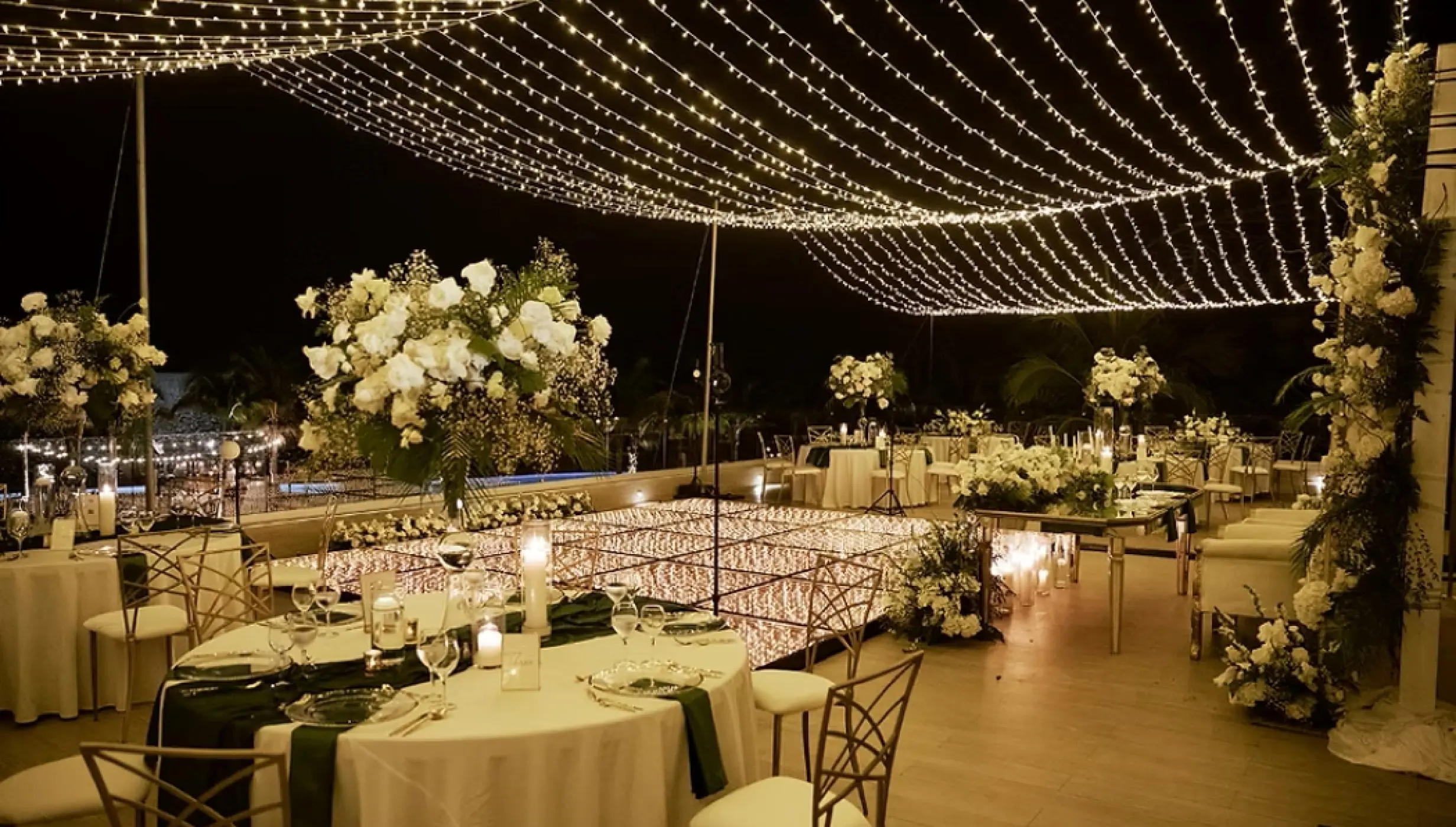 Rooftop wedding reception under string lights at Dreams Natura, Riviera Maya