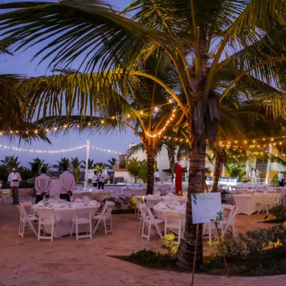 Outdoor wedding reception with string lights and palm trees at Dreams Onyx, Punta Cana