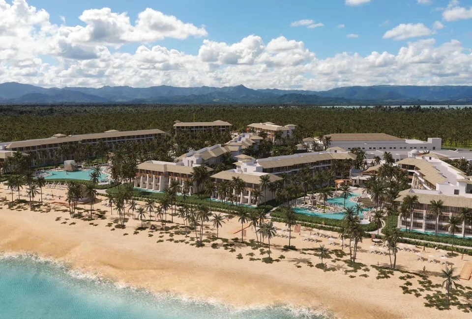 A stunning aerial view of the Dreams Playa Esmeralda resort, showcasing the pools, palm trees, and beach.