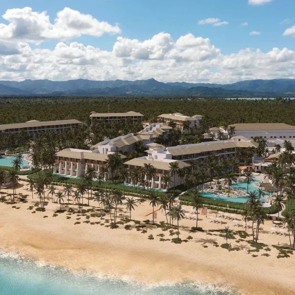 A stunning aerial view of the Dreams Playa Esmeralda resort, showcasing the pools, palm trees, and beach.