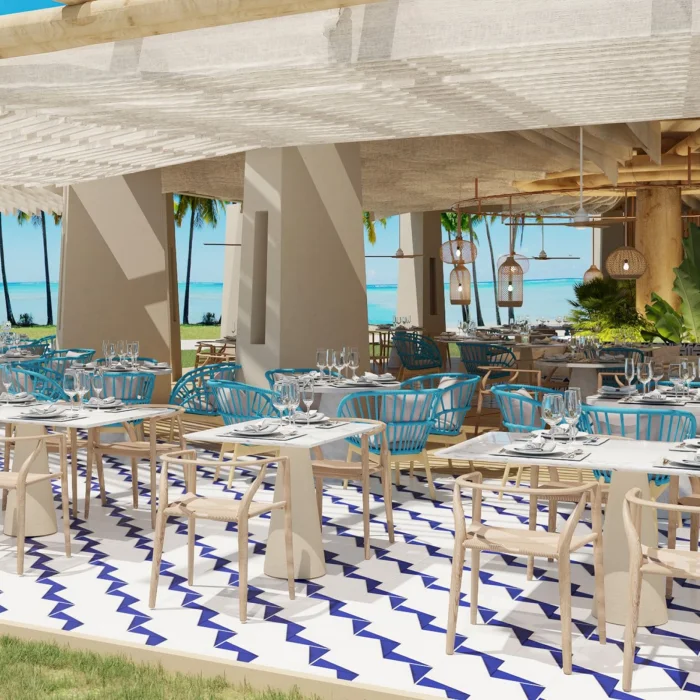 The outdoor dining area of the Bluewater Grill restaurant, with ocean views, blue chairs, and a covered terrace.