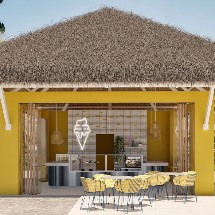 The Dolce ice cream parlor, a bright yellow building with a thatched roof and outdoor seating area.