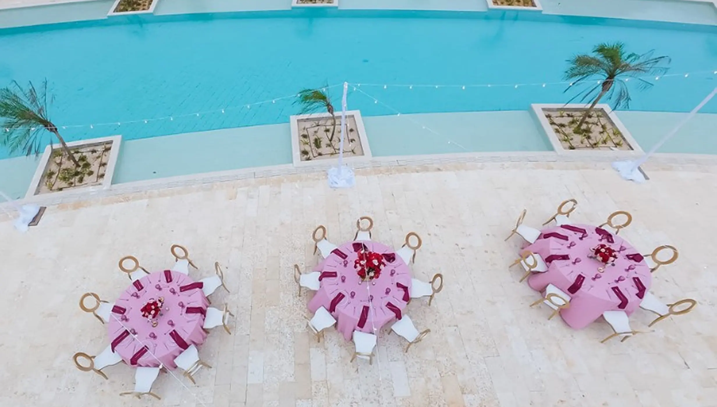 Overhead view of a wedding reception on the pool terrace at Dreams Playa Esmeralda, Miches