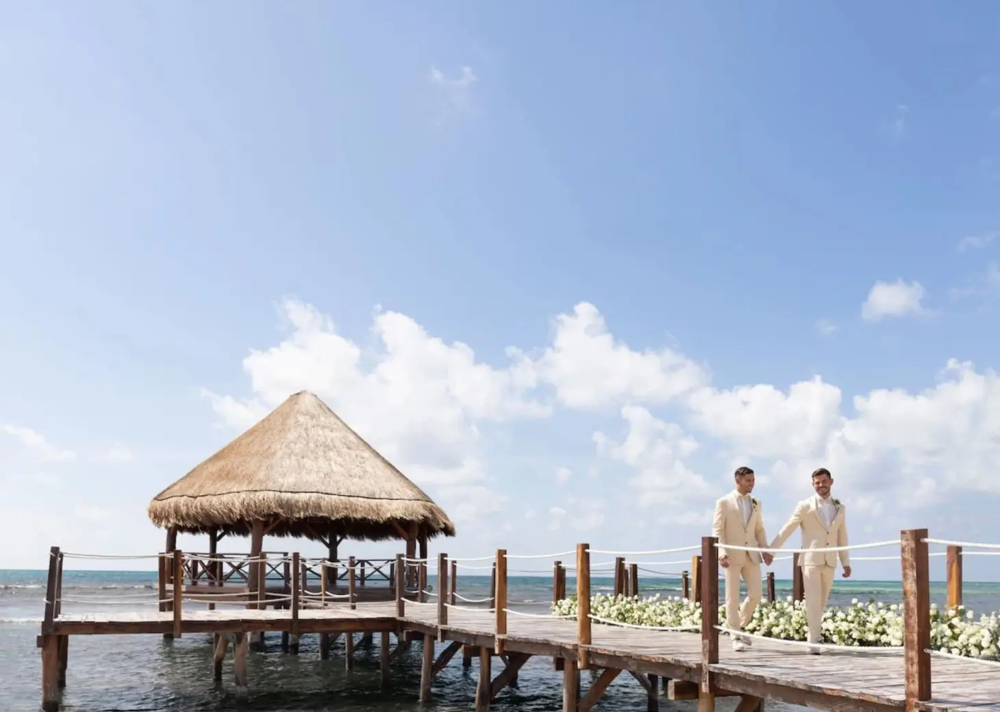 2 grooms at the overwater gazebo venue at Dreams Puerto Morelos Resort & Spa