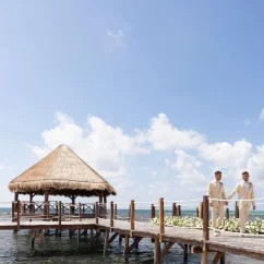 2 grooms at the overwater gazebo venue at Dreams Puerto Morelos Resort & Spa