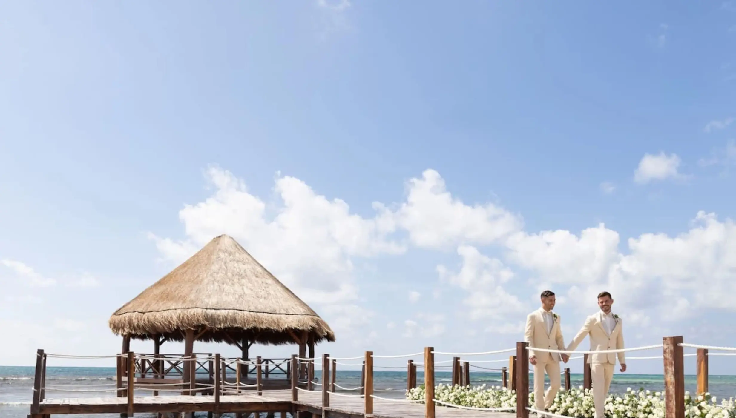2 grooms at the overwater gazebo venue at Dreams Puerto Morelos Resort & Spa