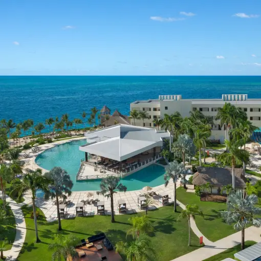 Aerial view of the main pool and beachfront grounds at Dreams Puerto Morelos, Riviera Maya