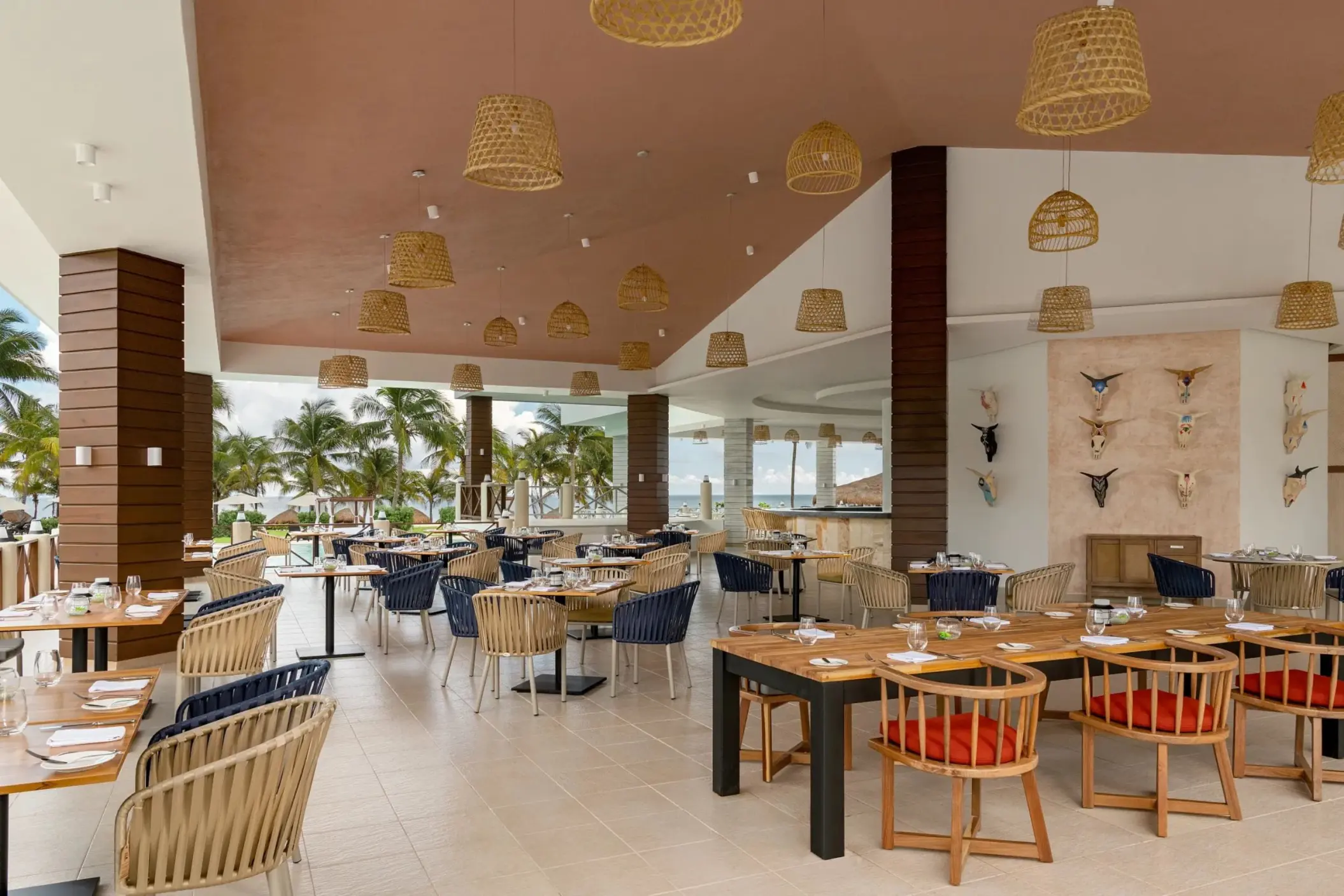 Open-air restaurant with woven light fixtures at Dreams Puerto Morelos, Riviera Maya