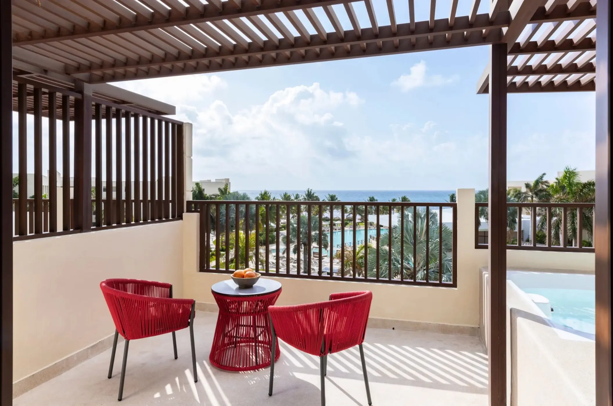 Private terrace with whirlpool and red seating at Dreams Puerto Morelos, Riviera Maya