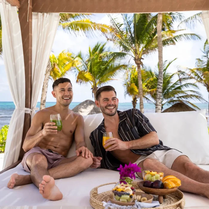 lgbtq couple in the poolside cabana at Dreams Puerto Morelos Resort & Spa