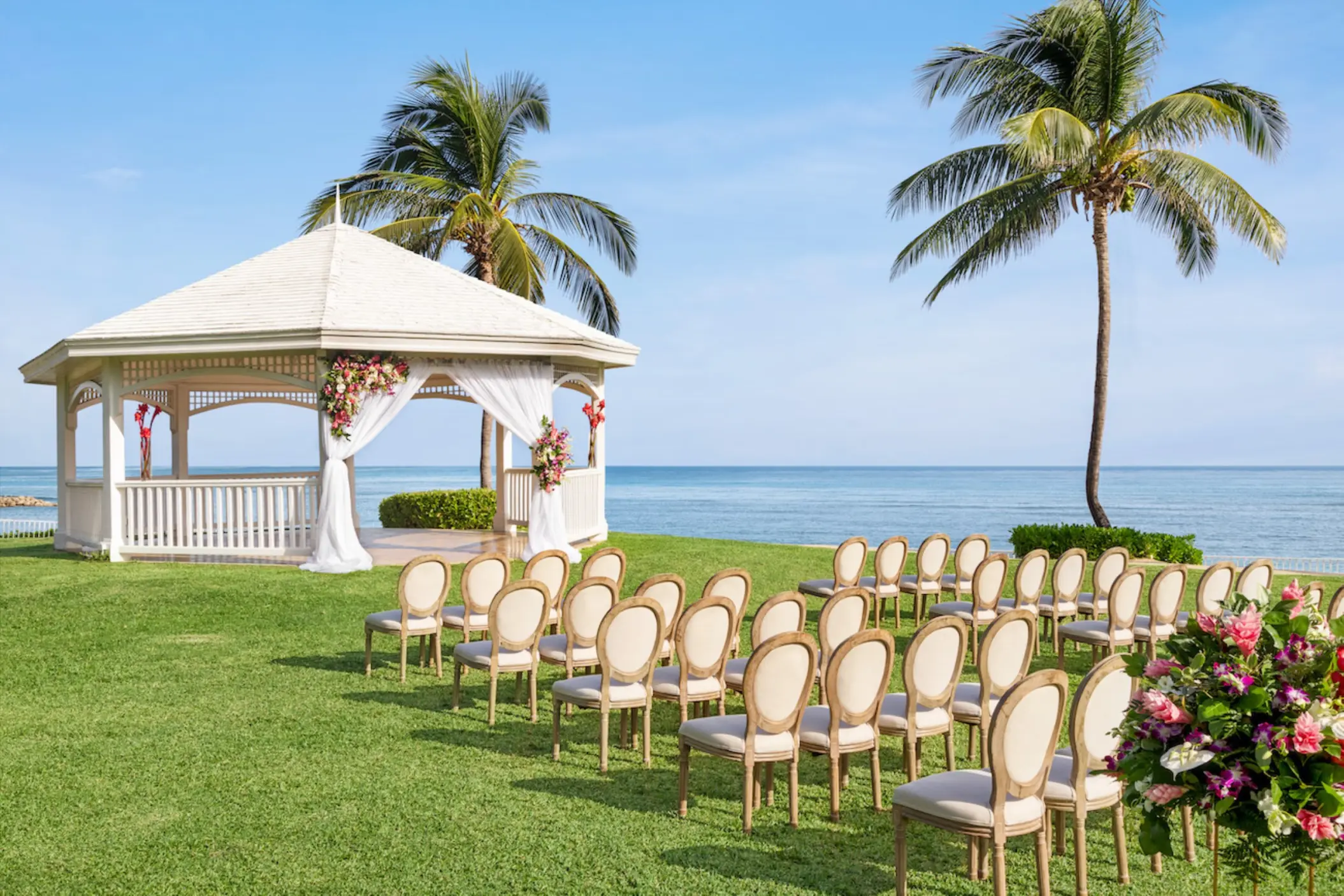 White oceanfront wedding gazebo and ceremony seating at Dreams Rose Hall, Montego Bay
