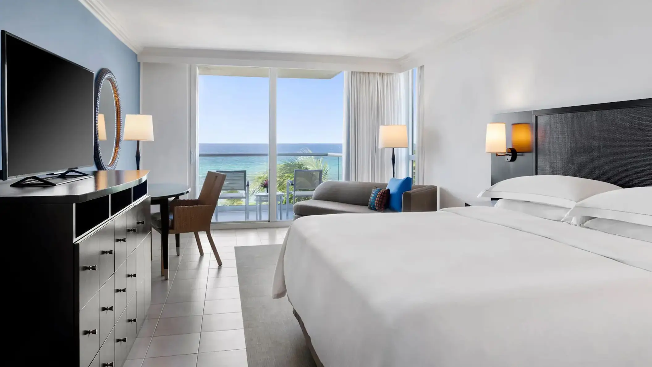 Oceanfront Royal Suite bedroom with balcony view at Dreams Rose Hall, Montego Bay