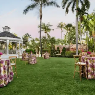 Garden cocktail hour setup with floral linens and a gazebo at Dreams Rose Hall, Montego Bay