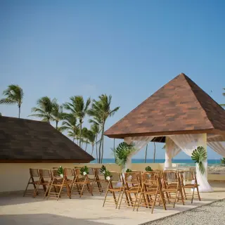 Royal Gazebo wedding ceremony with ocean views and wooden chairs at Dreams Royal Beach, Punta Cana