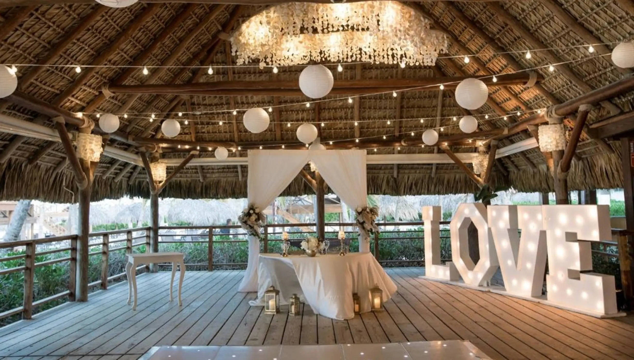 Sweetheart table and marquee LOVE sign at a Dreams Royal Beach Punta Cana wedding reception, Punta Cana