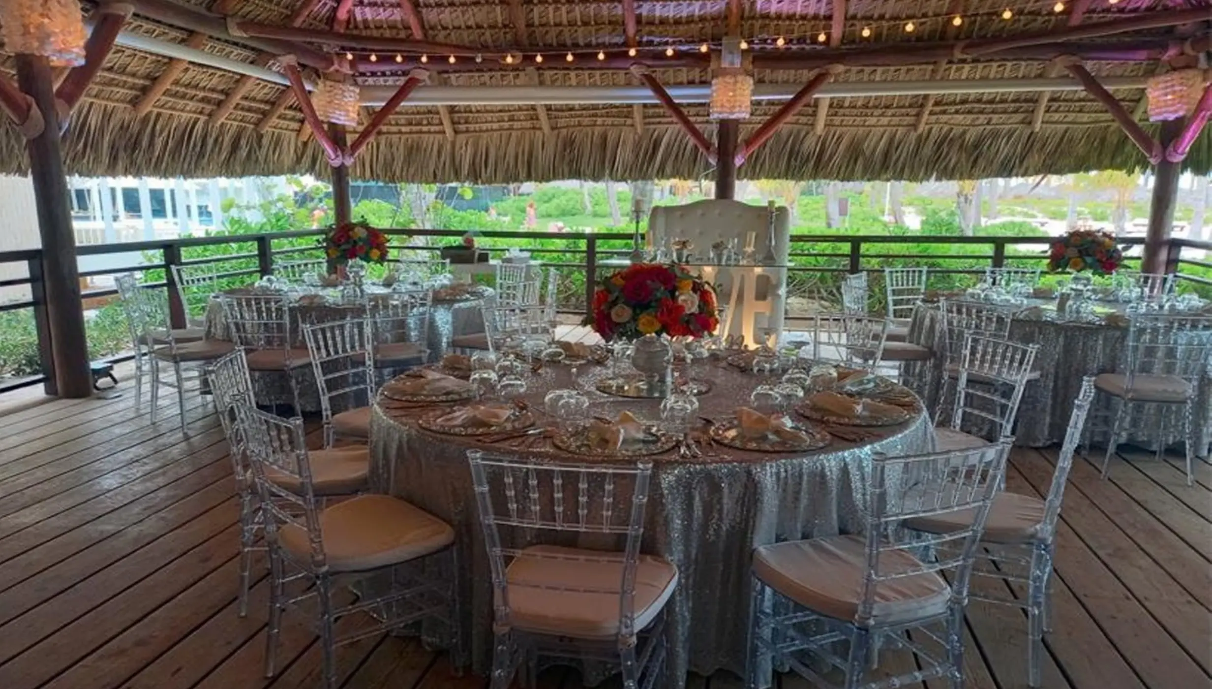 Seaside Grill wedding reception setup under a thatched palapa at Dreams Royal Beach, Punta Cana